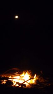 Beach bonfire with a full moon