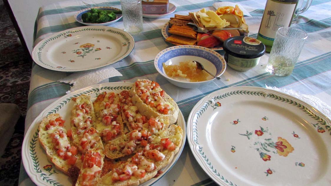 Bruchetta on homemade rosemary bread, three types of cheese, fruit, raw honey and wine for dinner!